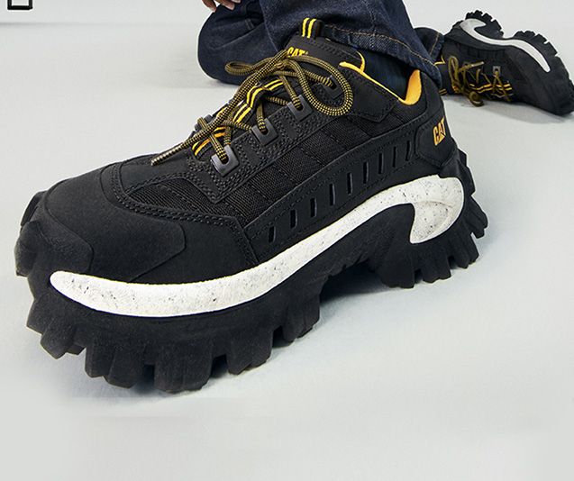 A black and yellow CAT Intruder shoe.
