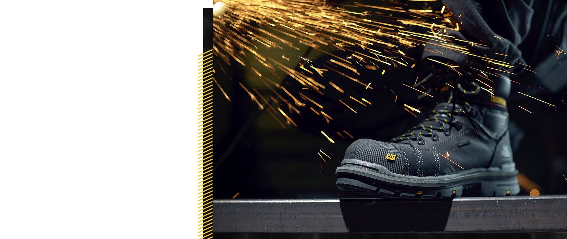 A person wearing black CAT safety shoe with yellow sparks coming out on it.