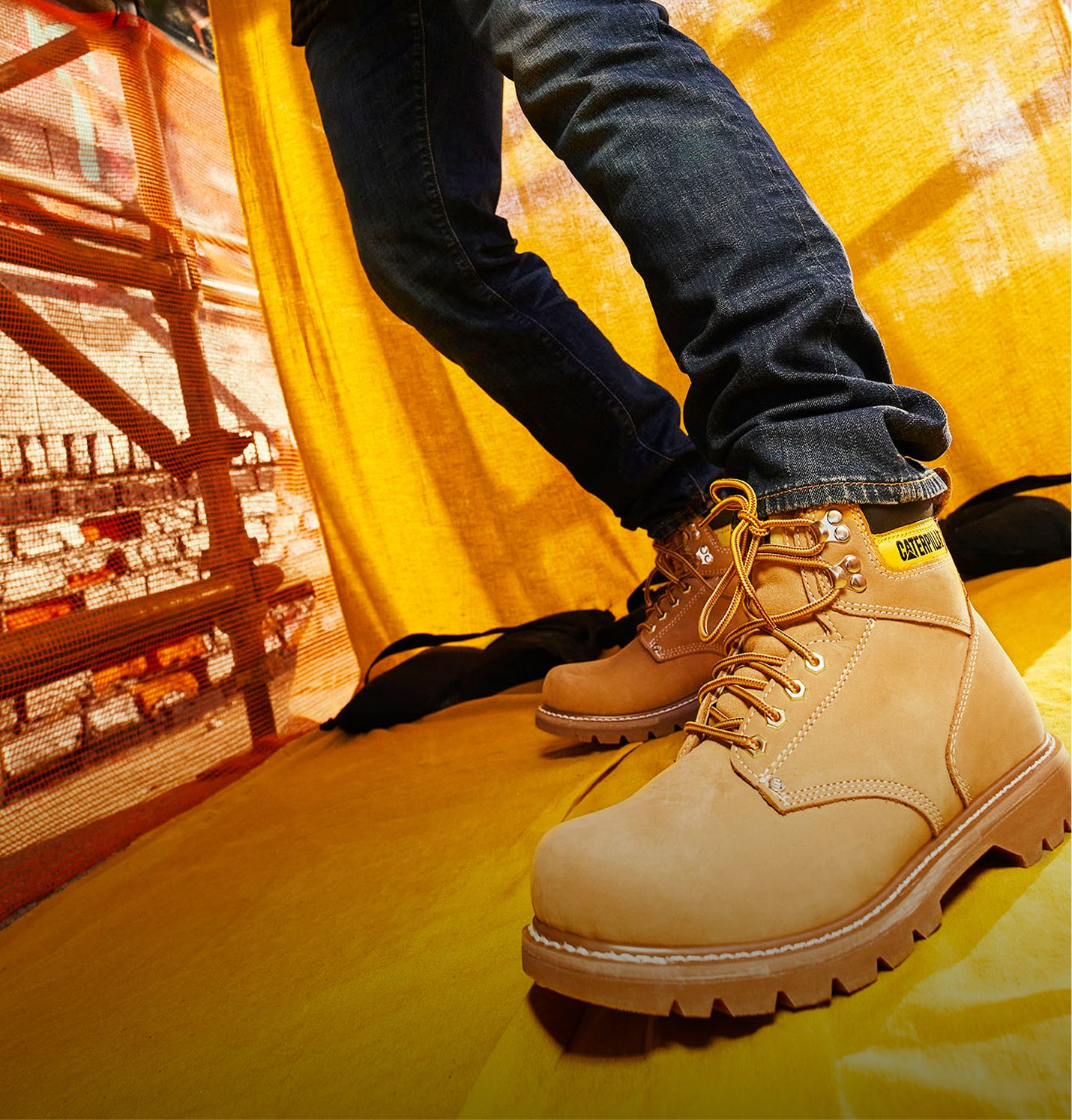 Tan boots standing under scaffolding.