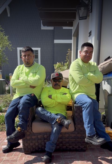 Three workers taking a break together at a job site.