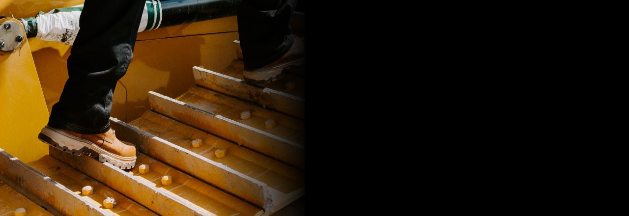 Boots walking on caterpillar tracks.