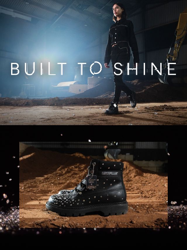 Black CAT boots encrusted with Svarovski crystals walking through a dirty storage shed.
