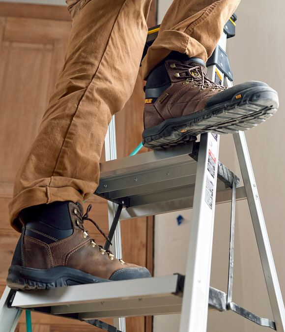Brown and black CAT Threshold boots