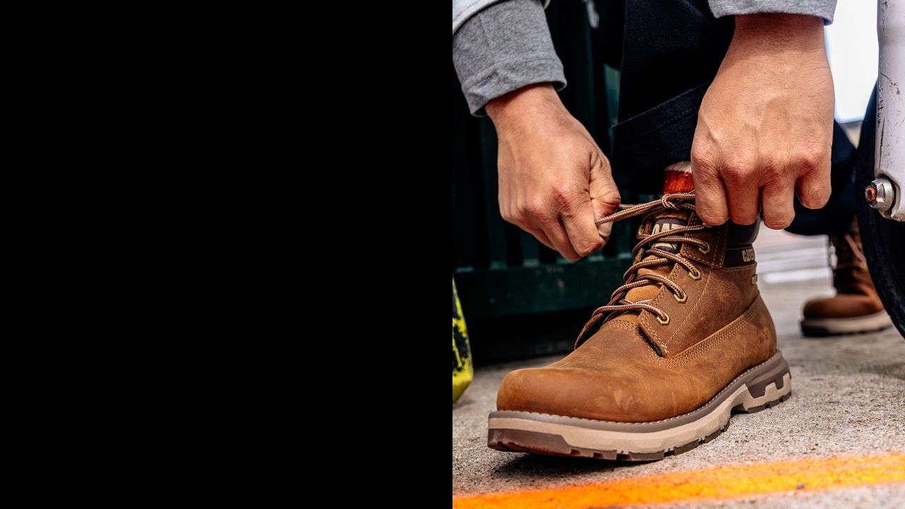 Tying the laces on brown boots.