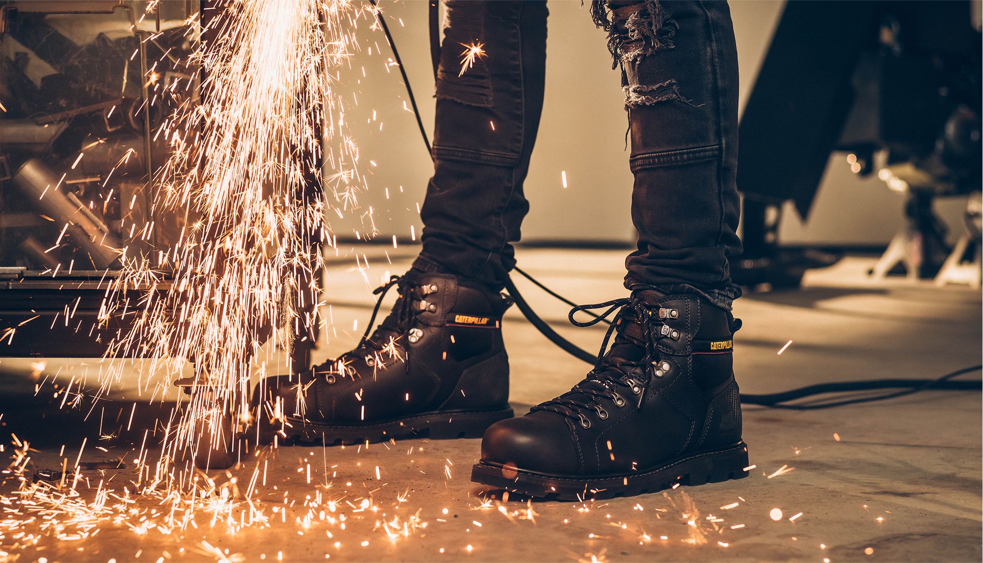 Boots being showered by sparks.