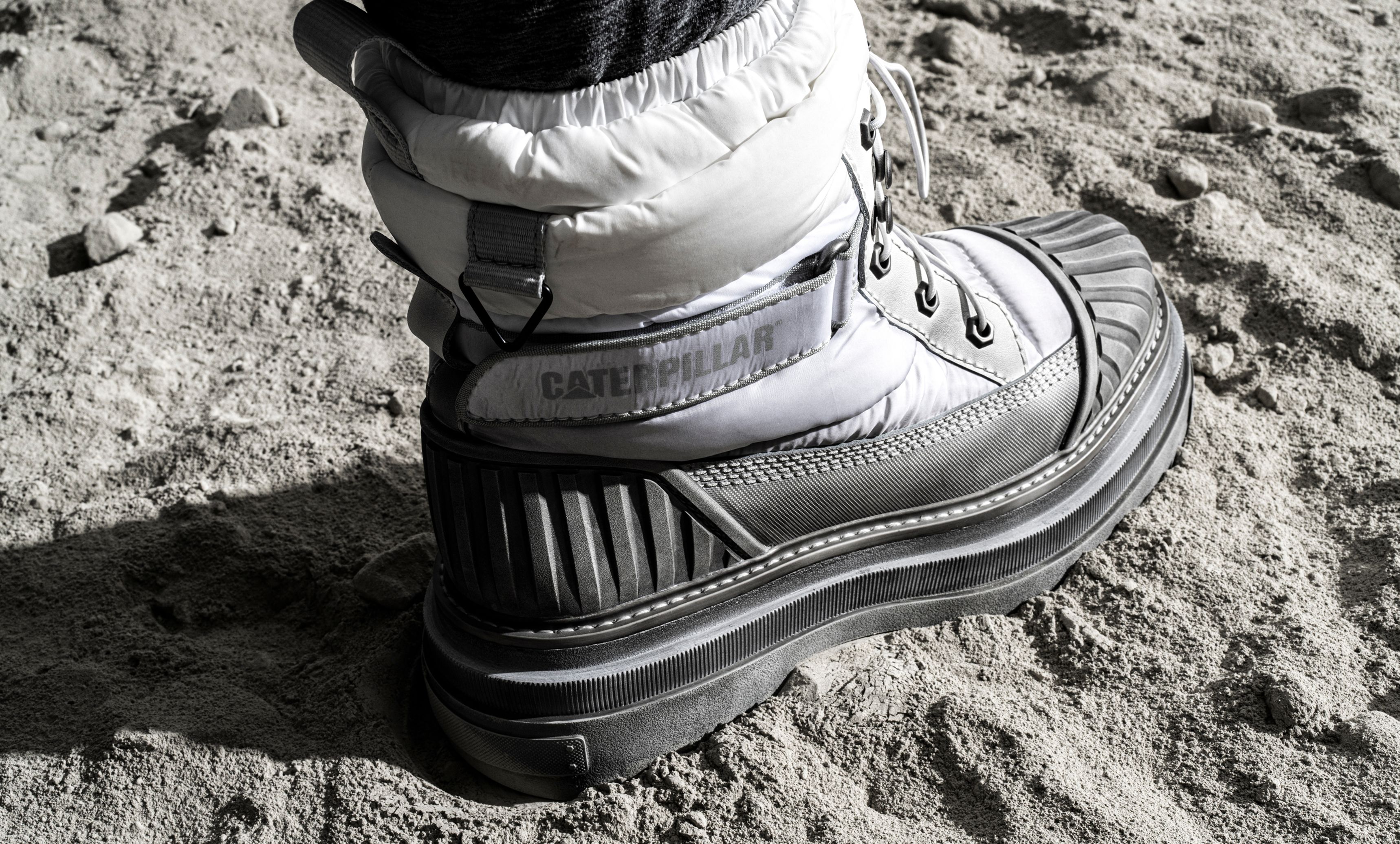 Apollo 11 boot stepping in moon dust on the lunar surface.