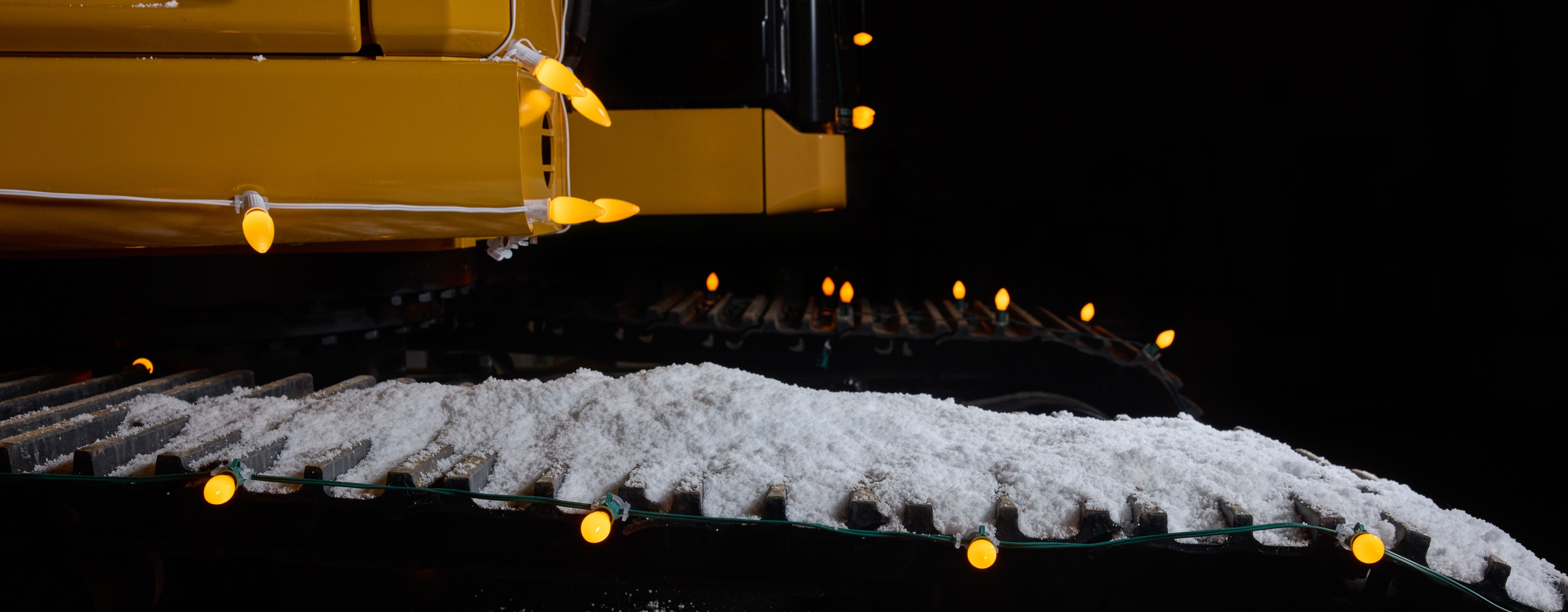 Snow with yellow Christmas lights.