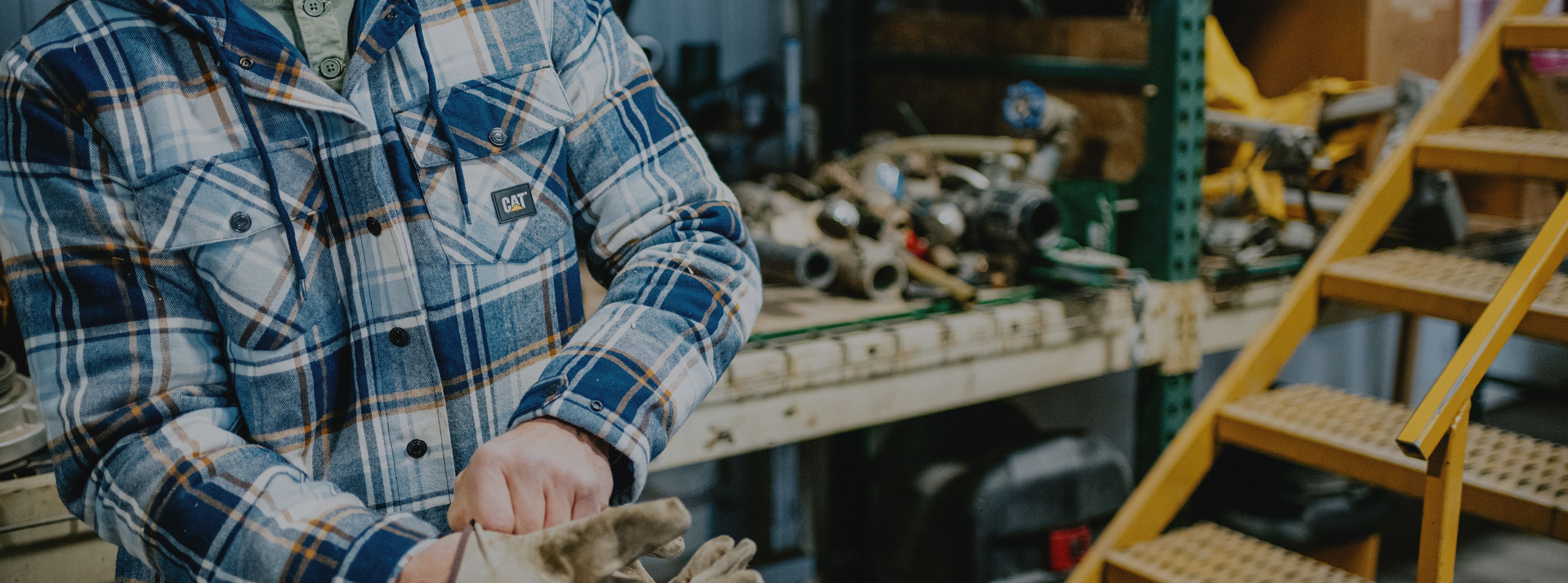 Pulling gloves on in a workshop.