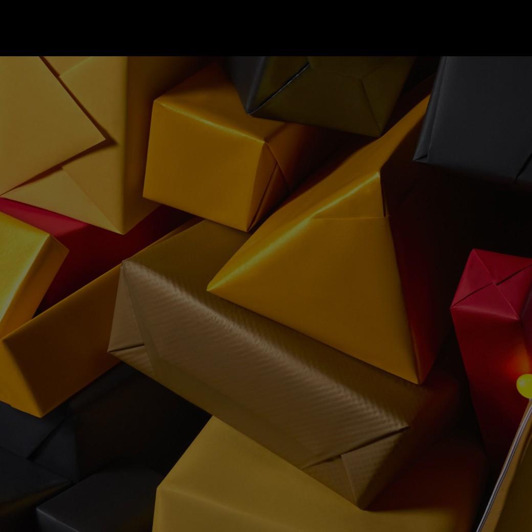 Gifts wrapped in yellow, black, and red paper.