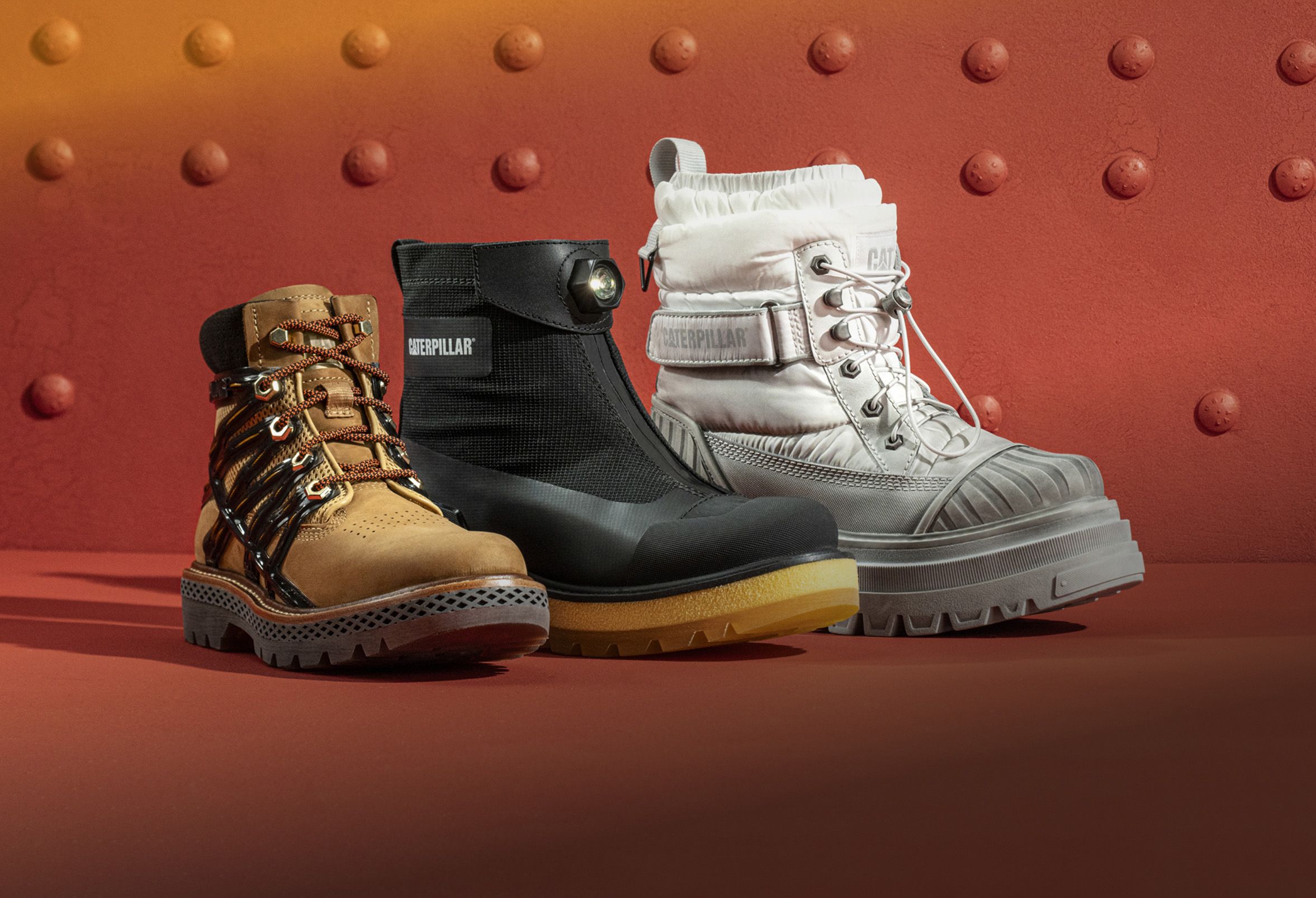 Boots from the Centennial Collection in front of a riveted steel plate.