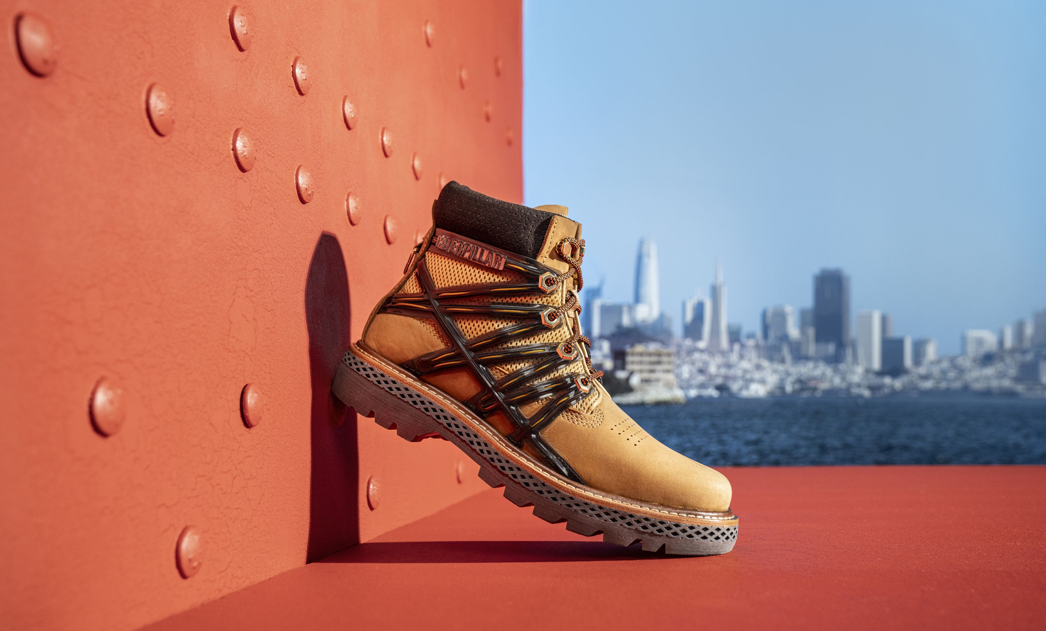 Brown boot on the Golden Gate Bridge with the San Francisco skyline in the background.