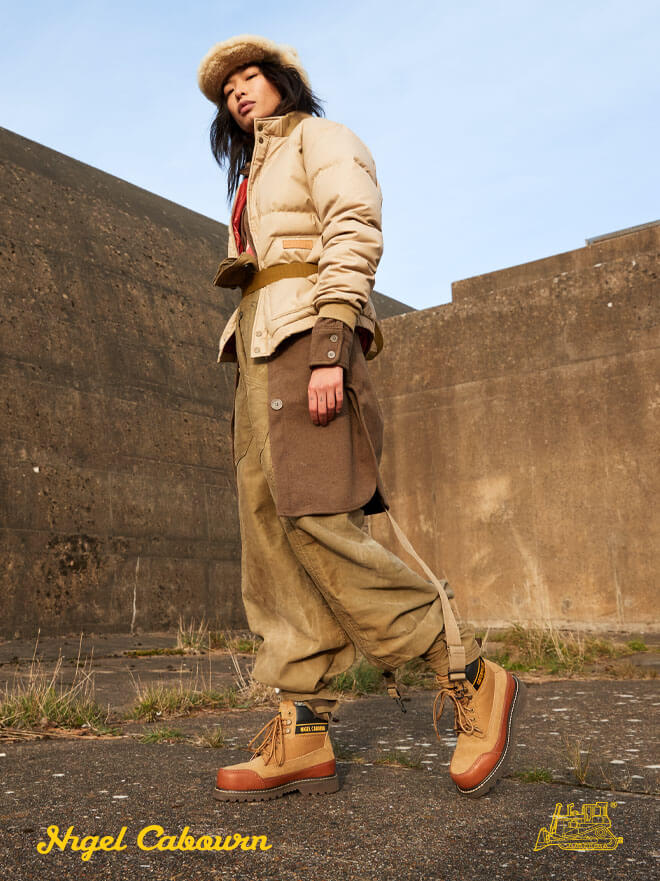 Nigel Cabourn signature. Split view with model wearing a pair of the collaboration footwear, and a pair of collaboration footwear.