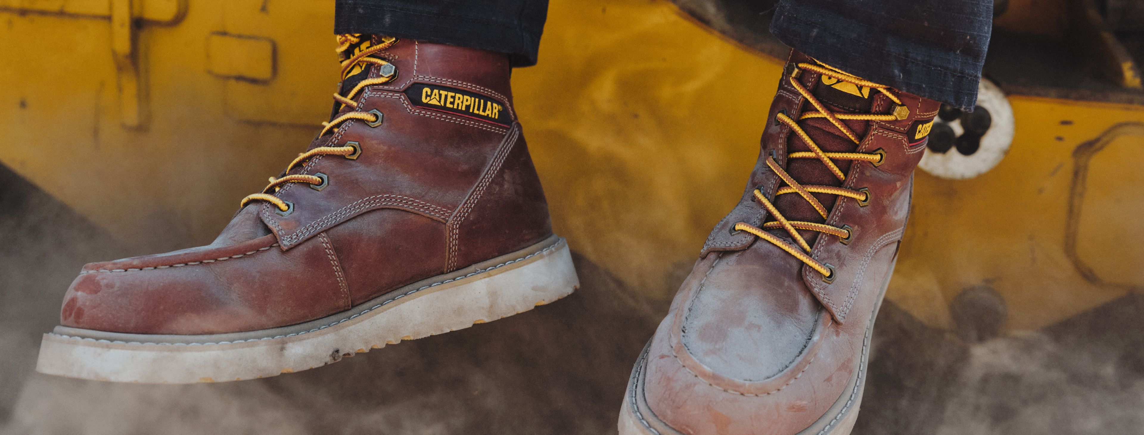 Boots dangling from heavy equipment.