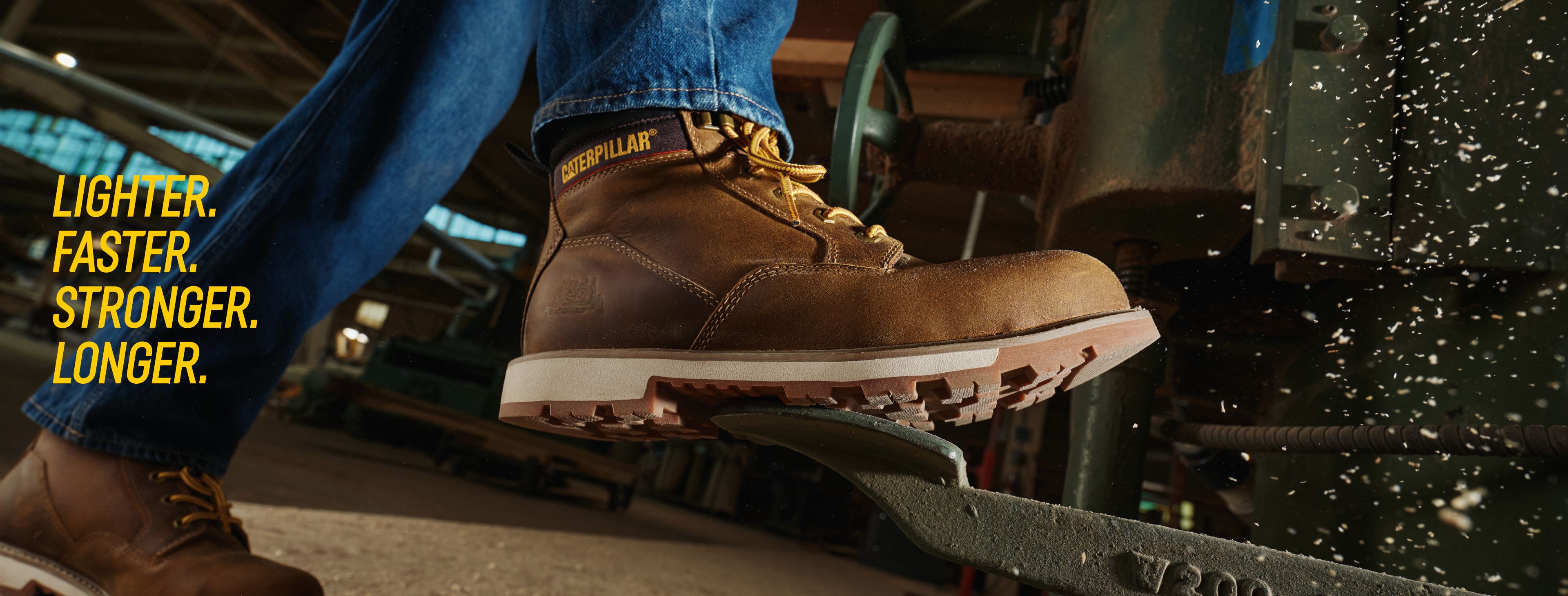 Workers wearing CAT work boots on a job site.
