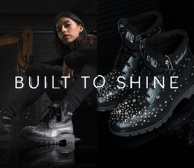 Close-up of black CAT boots encrusted with Svarovski crystals.