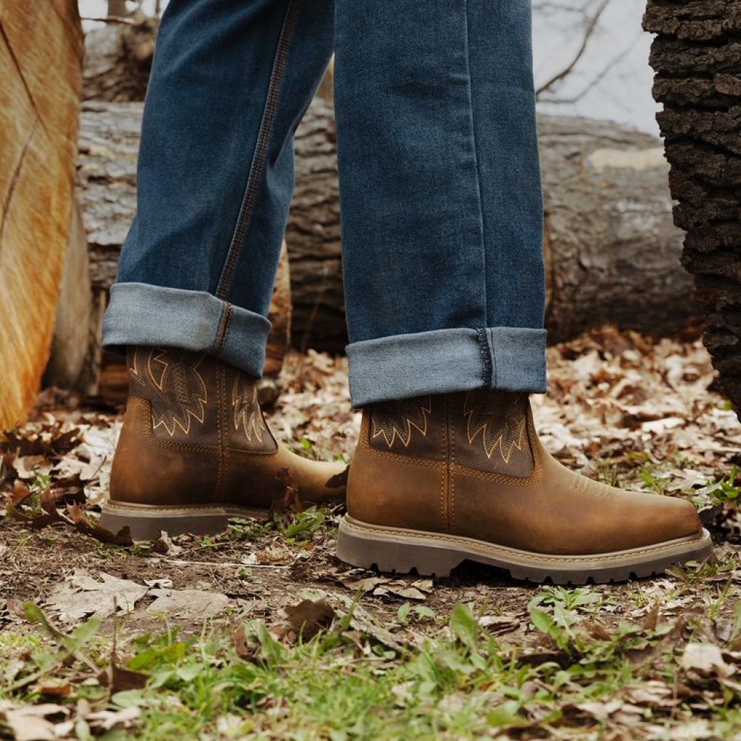Boots standing on fallen leaves.