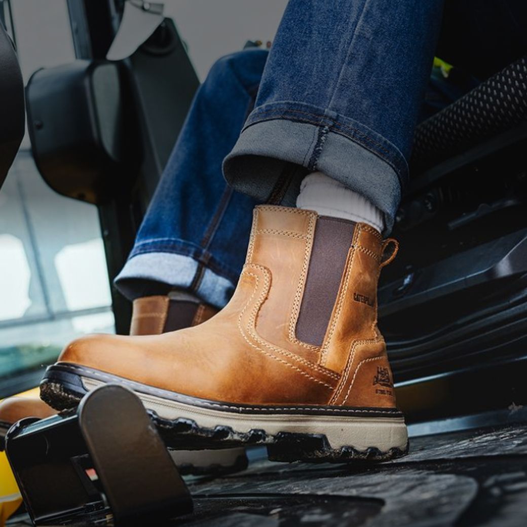 Boots on the pedals of heavy machinery.