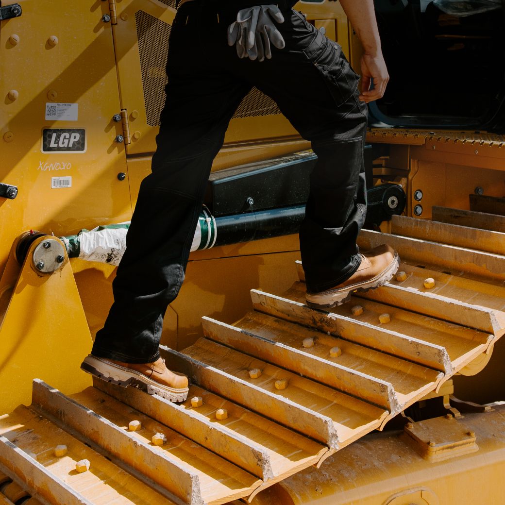 Boots walking on caterpillar tracks.
