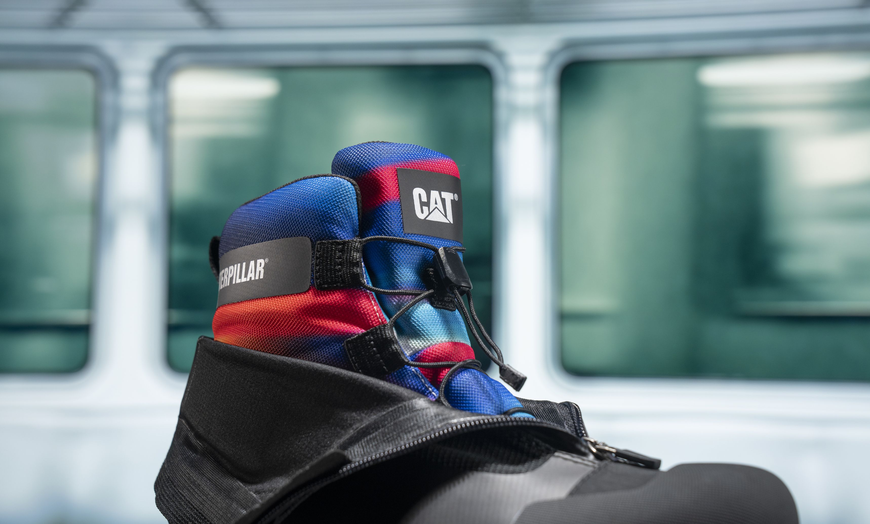 Channel Tunnel boot with black zippered shell partially removed revealing red and blue interior.
