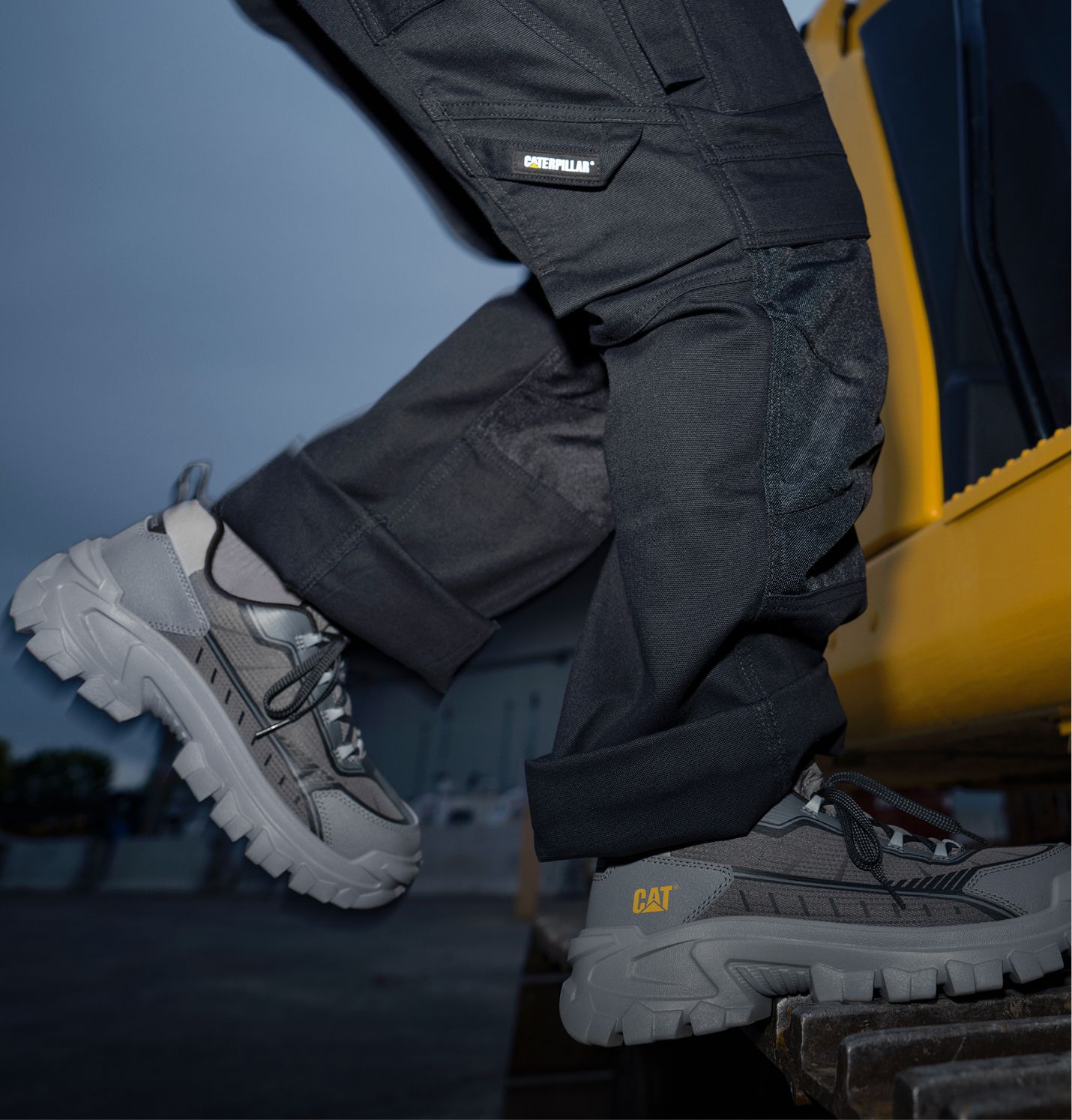 Shoes jumping onto the footplate of a bulldozer.