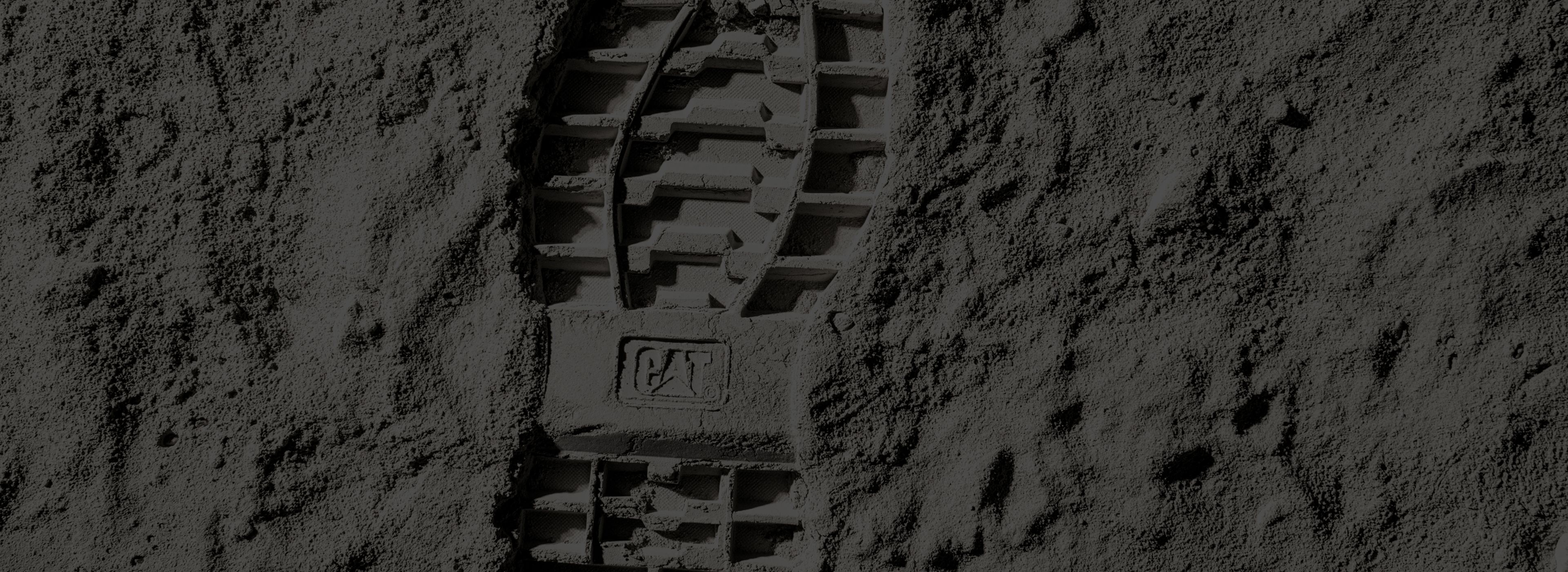 Footprints with CAT logo in moon dust.