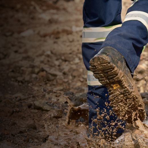 Boots walking through deep mud.