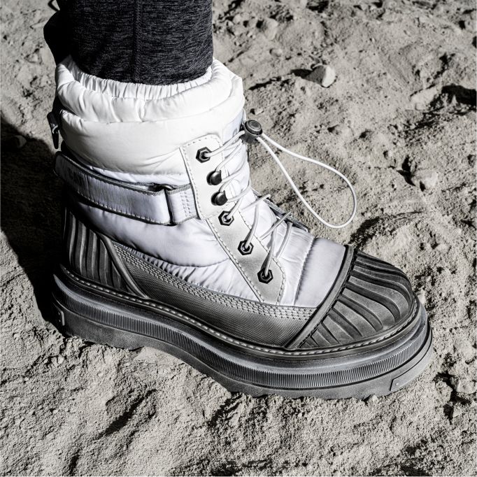 Boot standing on the lunar surface.