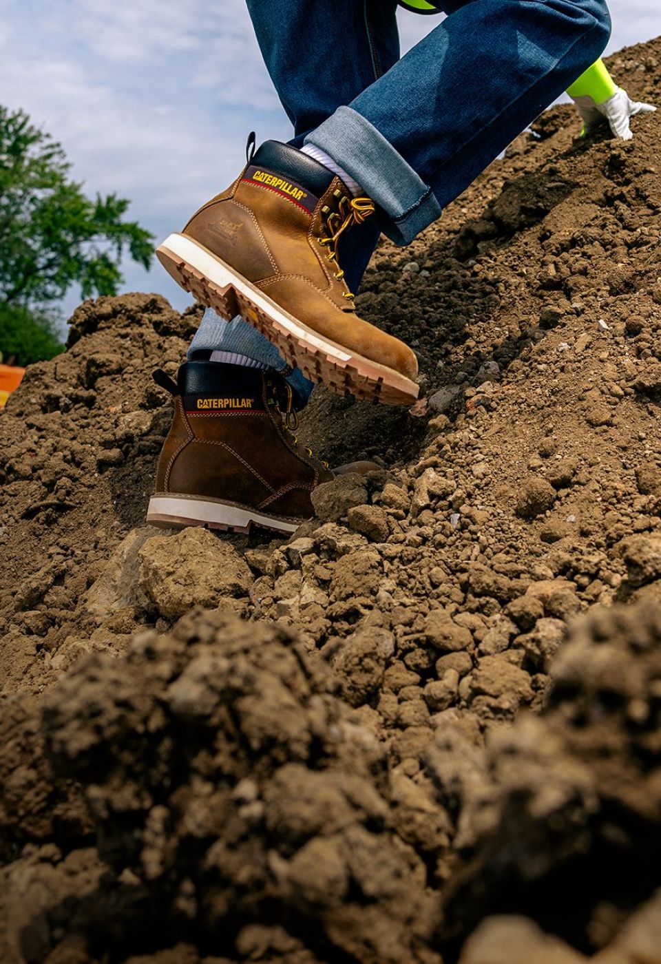 Man wearing CAT Second Shift work boots.